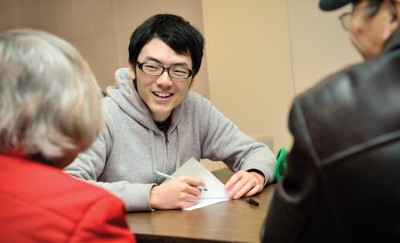 Student speaks with older adults