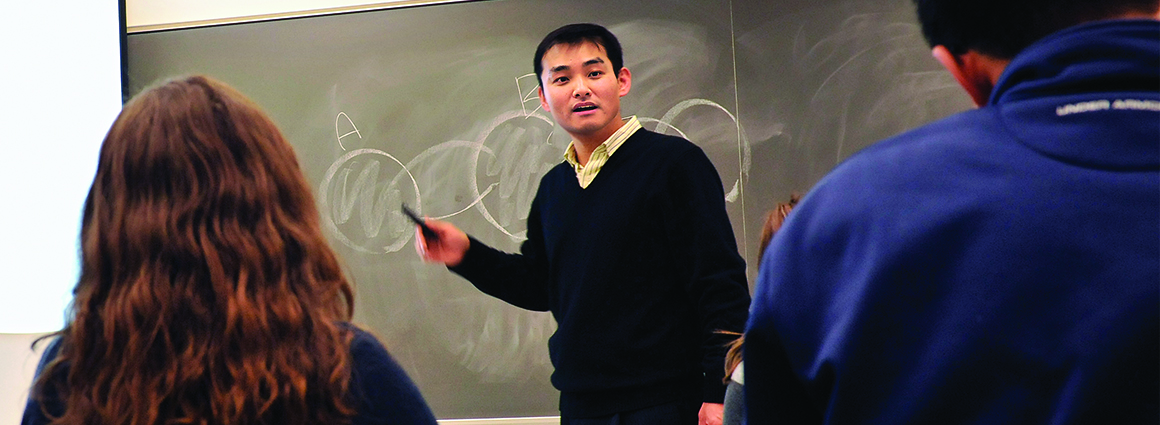 Professor in front of a chalkboard