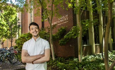 Joshua Jordan in front of the School of Social Policy & Practice