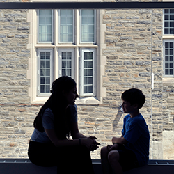 MSW student and child sit in window