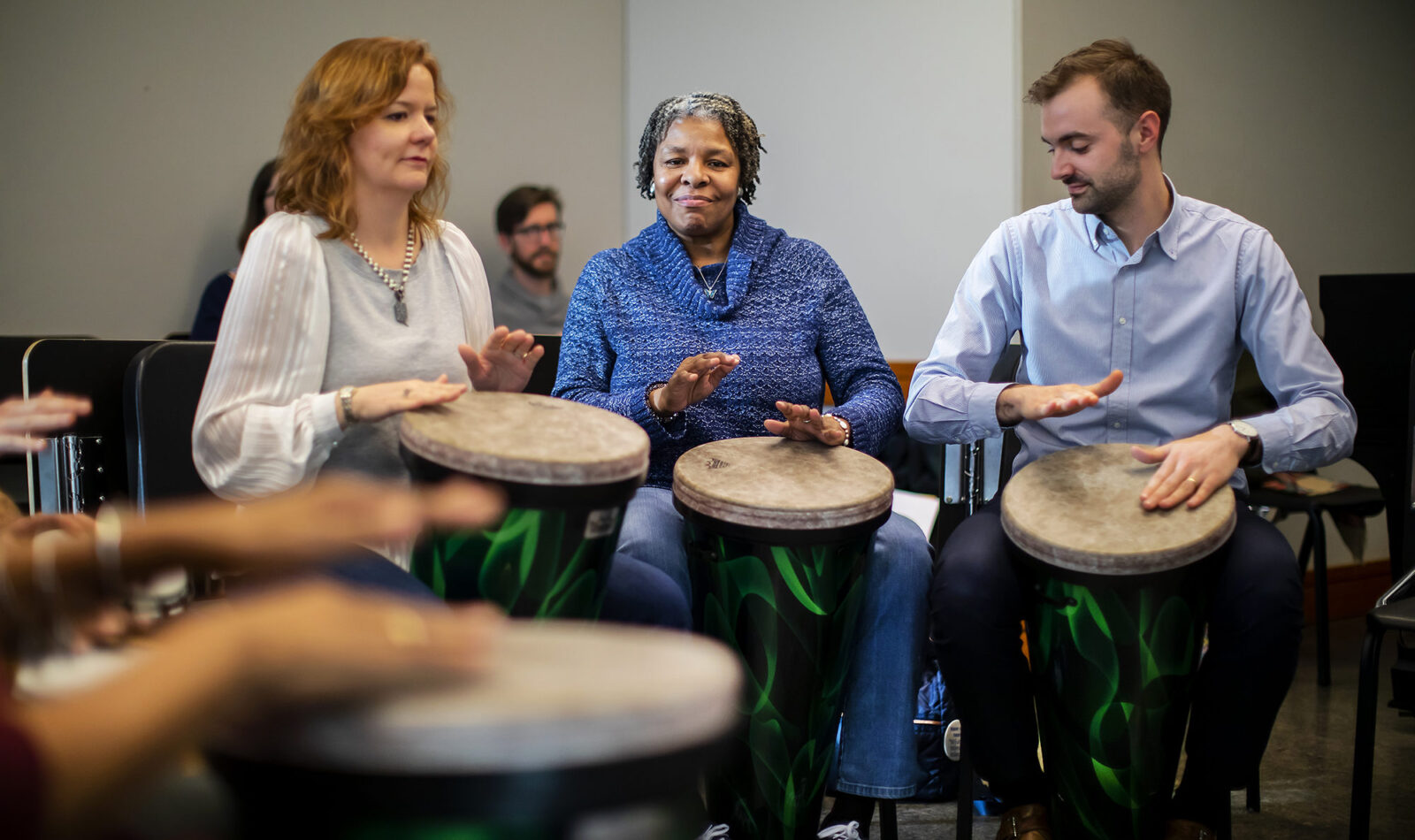 Mary Javian, chair of career studies at the Curtis Institute, Tempy Small, a program participant, and Adam Pangburn, coordinator of community performance at Curtis, participated in a drum circle at a “Creative Expression through Music” session. Nick DiBerardino (not pictured) lead the classes, which were coordinated by Penn graduate students Sarah Bujno and Matt Volpe (in the background).