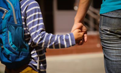 mother holding son's hand