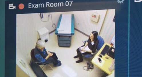aerial view of a student and an older patient meeting in a medical office