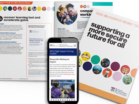 The High Impact Giving Toolkit appears on the screen of a phone placed on top of hard copies of the publication.