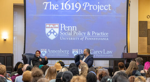 Nikole Hannah-Jones and Ben Jealous sit onstage before an audience. A blue screen behind them says "The 1619 Project" above the logos of Penn's School of Social Policy & Practice, the Annenberg School, and Penn Carey Law